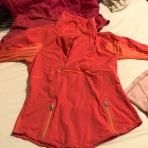 Long sleeve pull over two zipper pockets in the front ,quarter zip orange